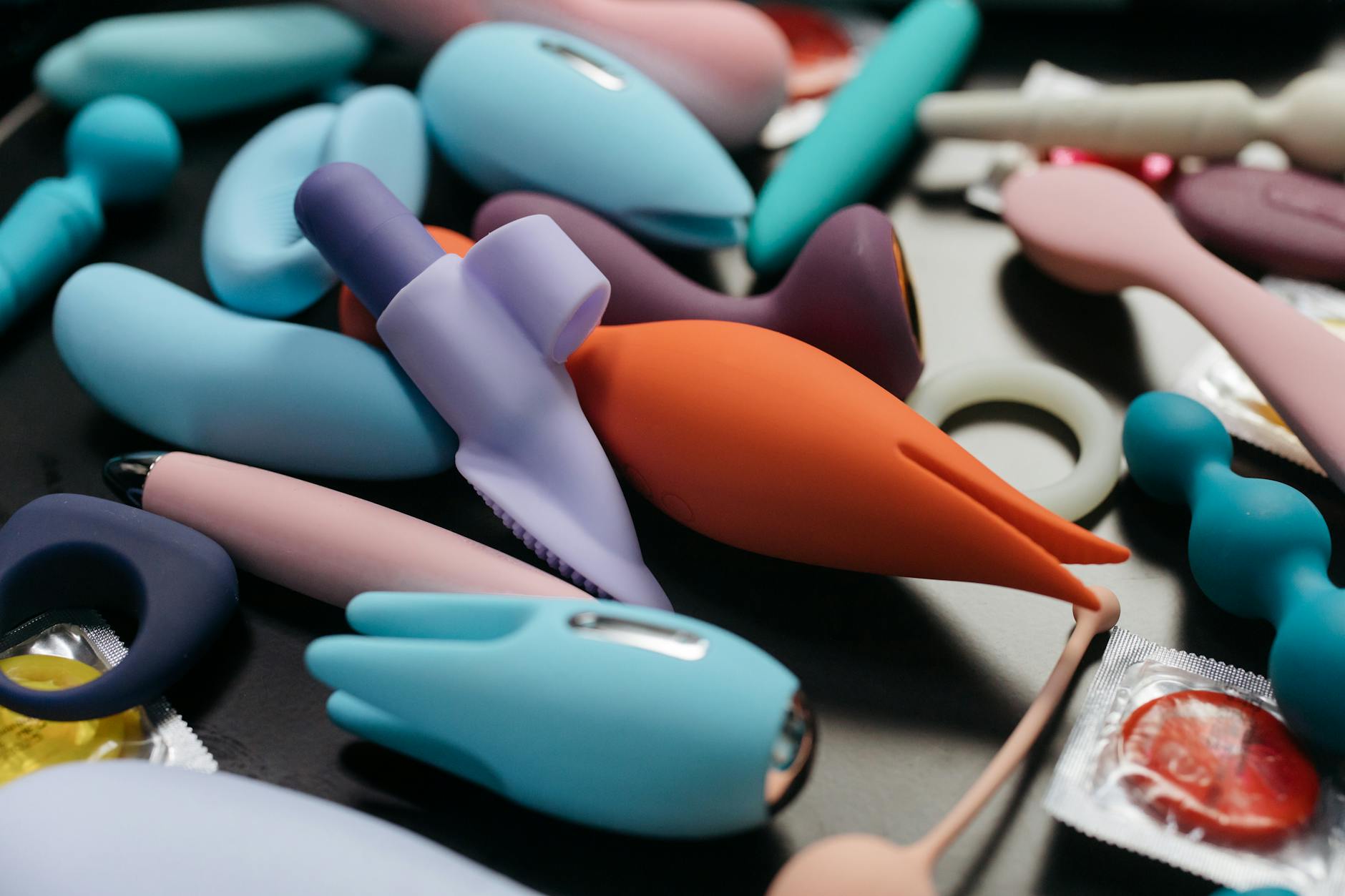 A collection of colorful silicone clitoral vibrators and wellness toys displayed in close-up