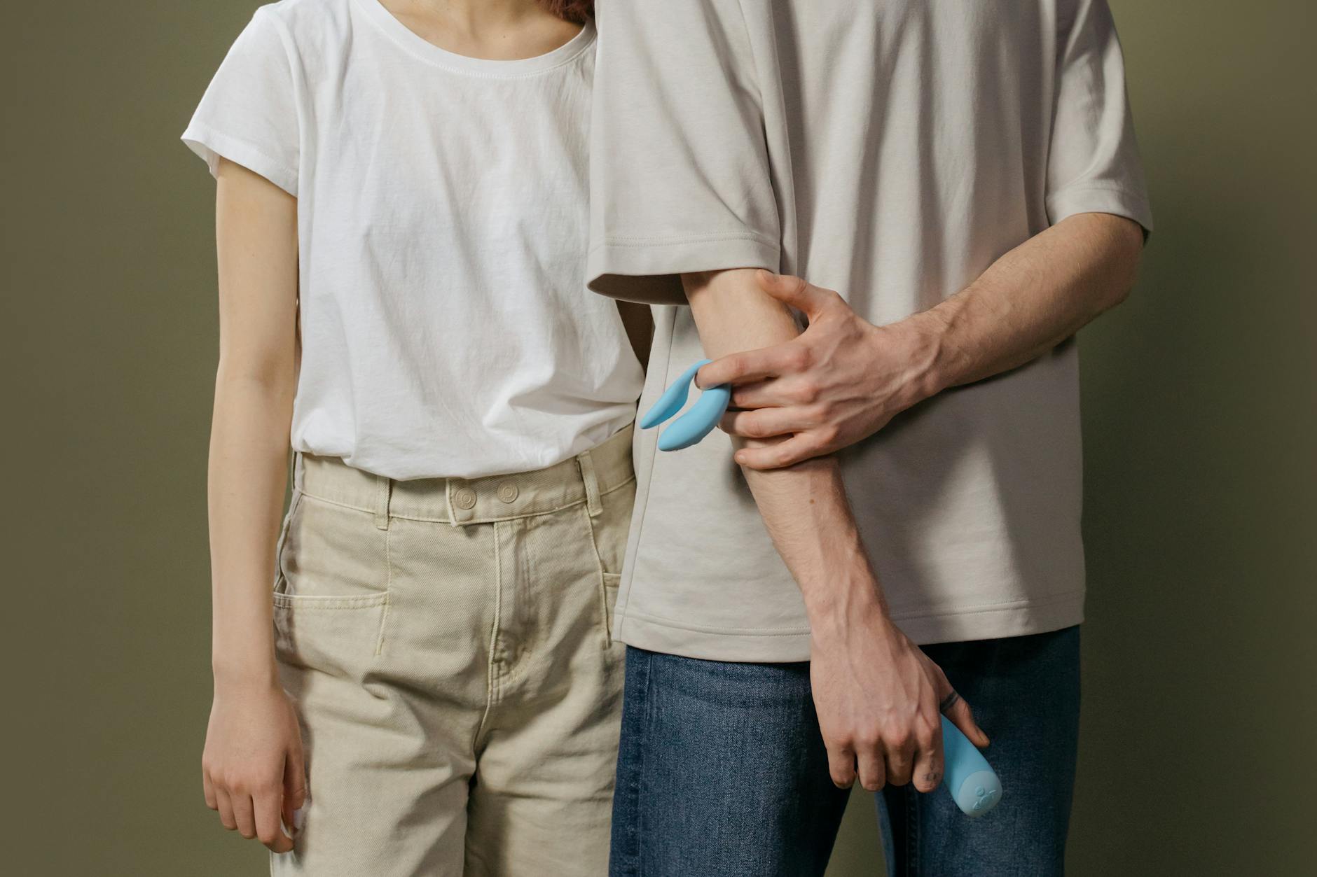 A couple standing together indoors, sharing an intimate moment with open communication.